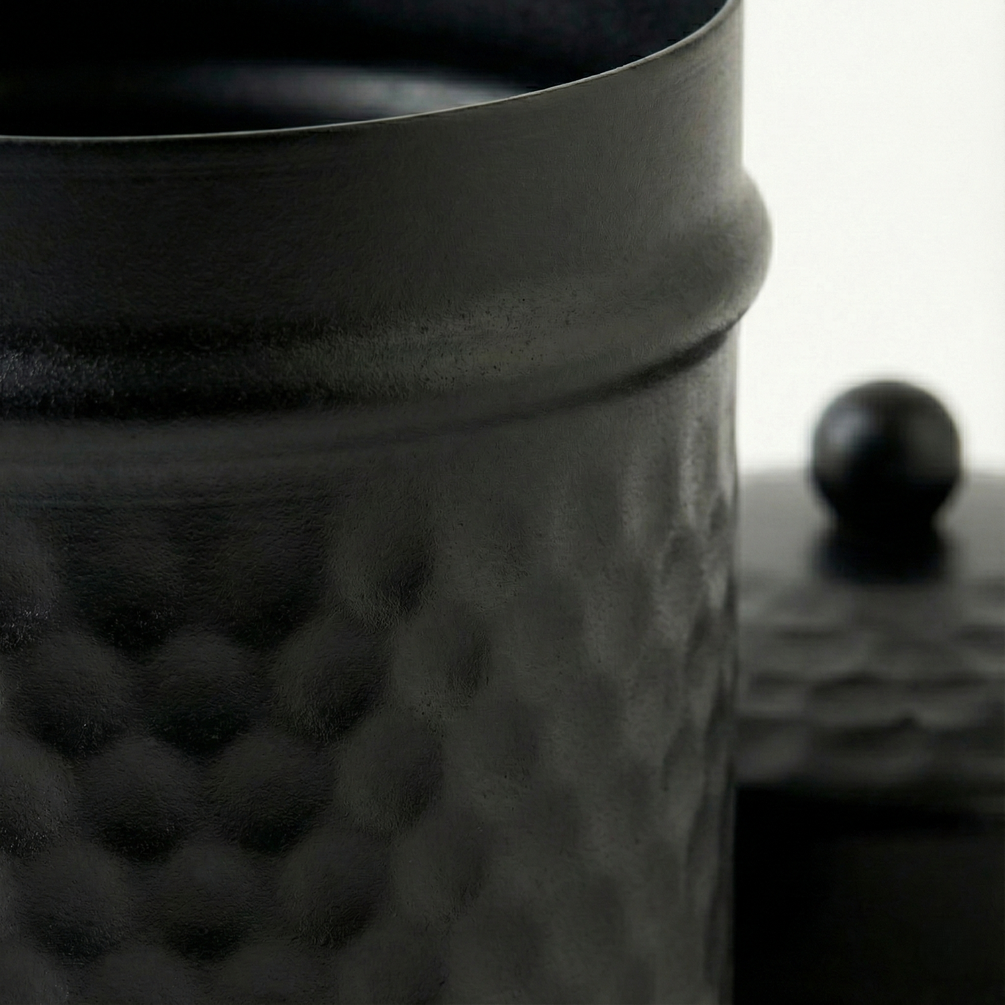 Macro detail of PreYog Matte Black Iron Jar showing smooth neck, raised ridge, and premium hammered metal texture.